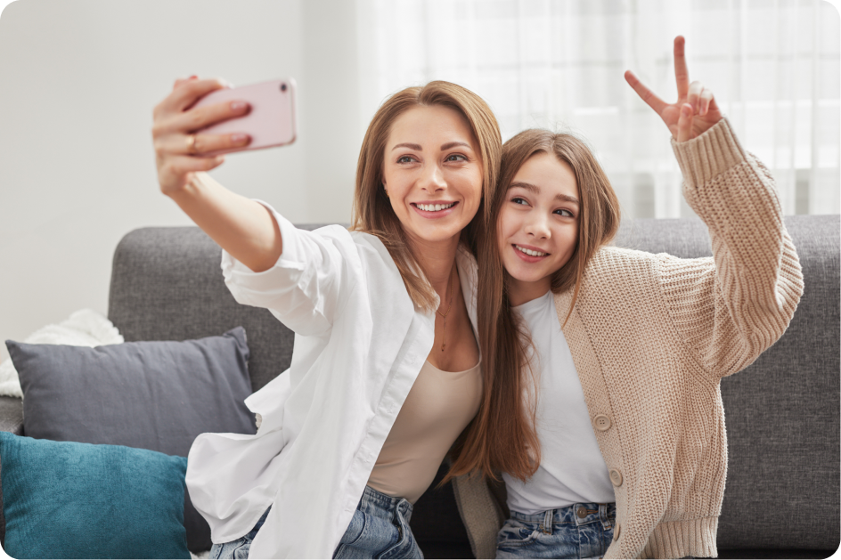 smiling-mother-and-daughter-taking-selfie-on-smart-2022-11-16-06-05-41-utc 2